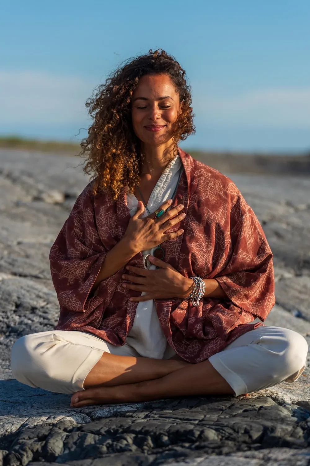 Charlene in meditation on rocks